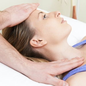 Osteopath Treating Female Patient With Neck Problem